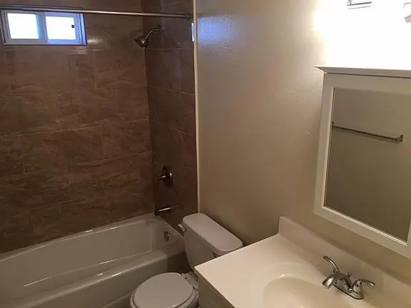 Bathroom with a tub and shower in a residence at 635 11th Street.